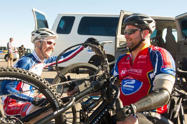 At left, Ray Clark, Program Manager for Ride 2 Recovery's "Project Hero" at Walter Reed, and John Masson, a U.S. Army Special Forces Veteran, prepare for the Ride 2 Recovery Las Vegas Mountain Bike Challenge at Blue Diamond Monday, Jan. 27, 2014. Masson, who lost 3 limbs during a roadside bomb attack in Afghanistan in Oct. of 2010, is among many wounded veterans who are being helped by Ride 2 Recovery, a nonprofit organization that provides rehabilitation to injured veterans through cycling.